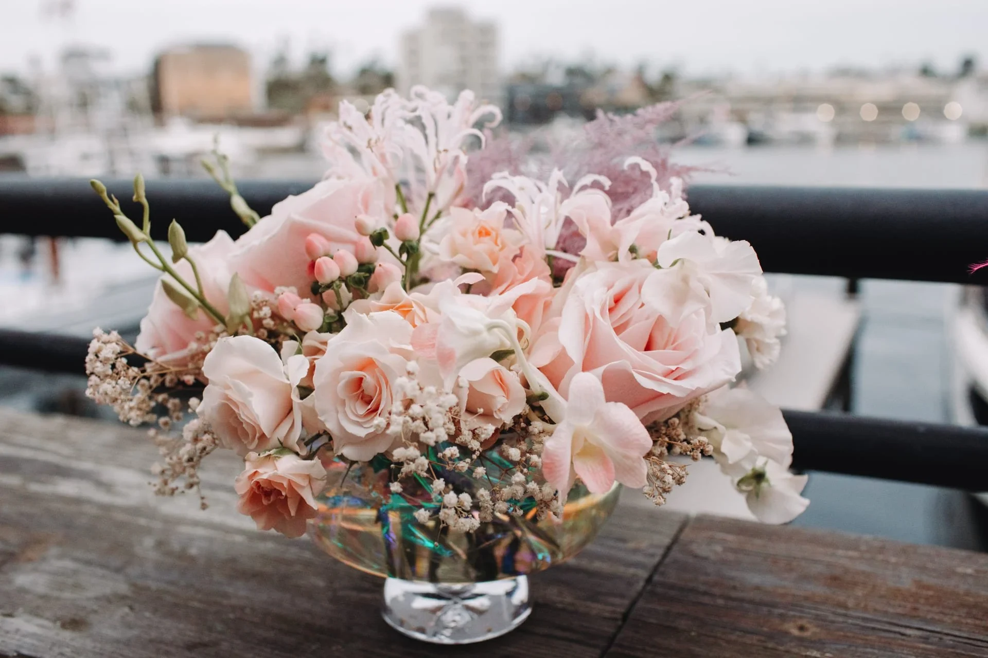 Roses and orchids in a glass bowl at the marina